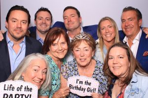 A group of friends celebrating a birthday at our booth.