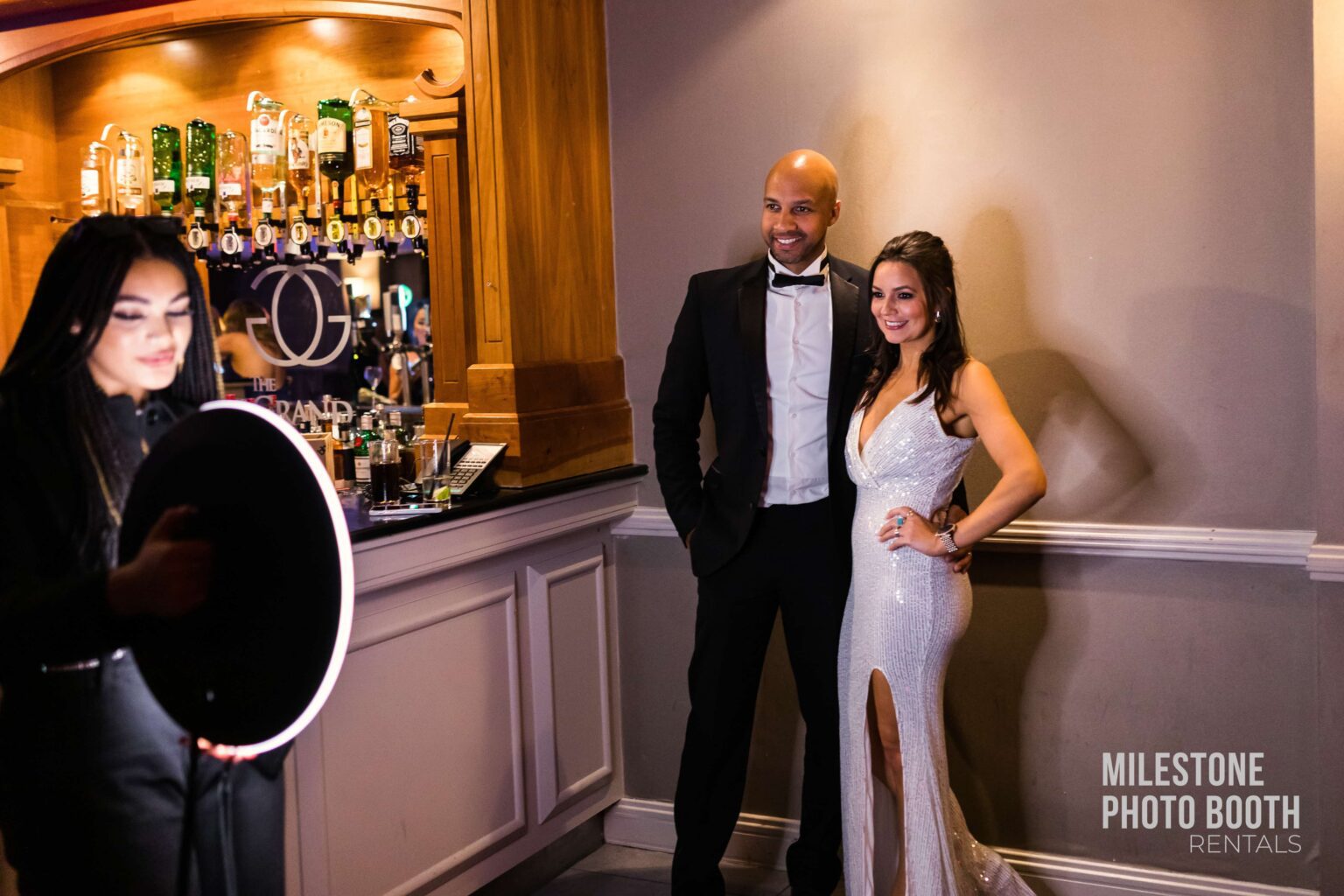 A well-dressed couple posing in an elegant cocktail lounge, attending a black-tie corporate event at Milestone NJ.