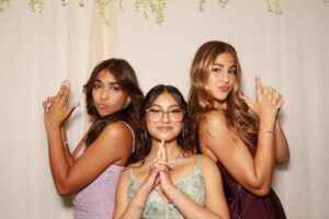 Three girls dressed in elegant outfits striking a confident pose at Milestone NJ.
