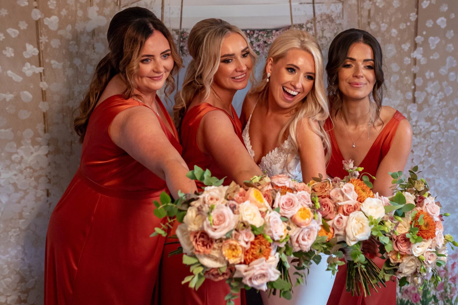A bride throwing her bouquet with guests in the background - Milestone Photo Booths.