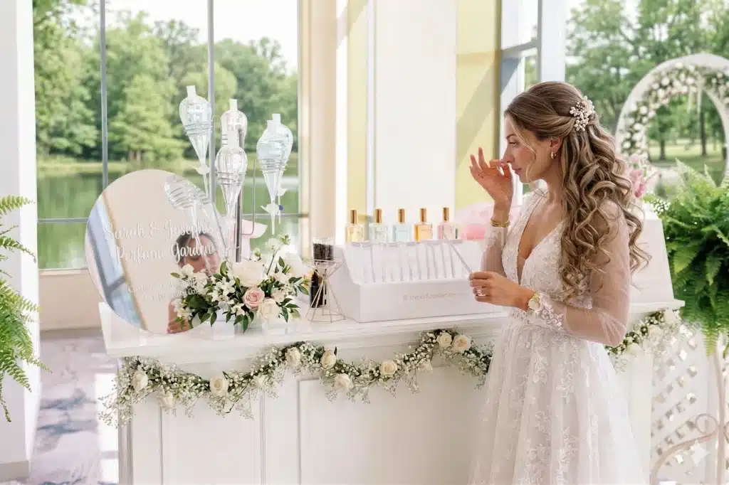 Luxury wedding perfume bar with elegant fragrance bottles and custom scent station where guests create personalized perfumes during an immersive wedding reception.