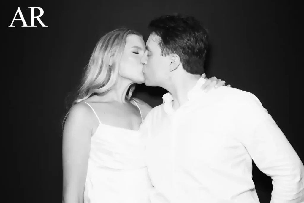 Backyard tent wedding photo booth black and white Glam Noir portrait of a couple kissing with AR initials overlay in the corner